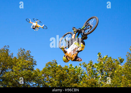 Sofia, Bulgarien - 24. September 2016: Biker springt gegen den blauen Himmel und Bäume begleitet von einer Drohne. Stockfoto