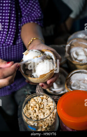 Frau serviert Kokosnuss Eis schwimmenden Markt Damnoen Saduak außerhalb Bangkok Thailand Stockfoto