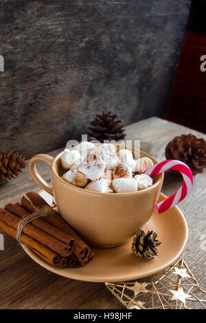 Heiße Schokolade mit Marshmallows, Zimt und Pfefferminze candy Cane über rustikalen Tisch close up - hausgemachte festliches Heißgetränk für Weihnachten und Winter h Stockfoto