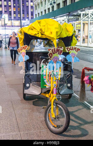 Pedal powered Rikscha bedeckt mit anti-Trump Parolen, New York City, Vereinigte Staaten von Amerika. Stockfoto