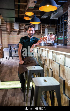 Unternehmer, die sitzen am Tresen von seinen Coffee-shop Stockfoto