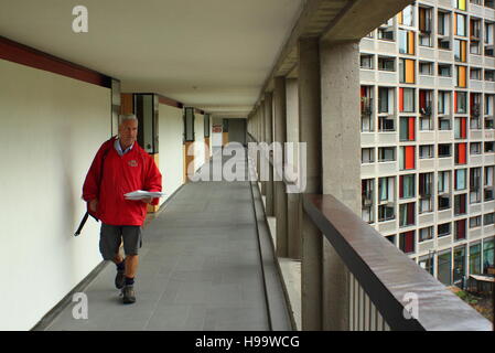 Royal Mail Arbeiter liefert Post an Wohnungen in einem sanierten Flanke der Park Hill Wohnungen in Sheffield, Yorkshire, England - 2016 Stockfoto