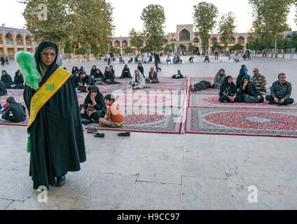 Weibliche Garde mit einem grünen Staubwedel am Mausoleum von Shah-e-Cheragh, Fars Provinz, Shiraz, Iran Stockfoto