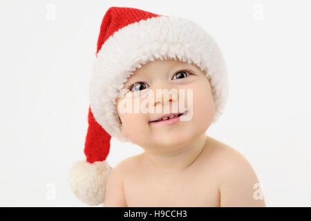 Lächelnde junge in der Weihnachtsmütze. Santa Baby Stockfoto