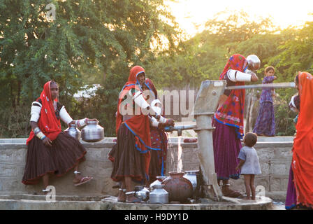 Stammes-Frauen sammeln Wasser aus dem Dorf in den Hügeln von Bhenswara, außerhalb der Rajasthani Stadt Johdpur, Indien. Stockfoto