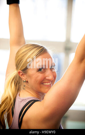 Lächelnde Frau kaukasischen trainieren Sie im Fitnessraum Stockfoto