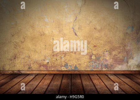 leere Muster Zimmer mit Holzboden Eiche und Stein Betonwand orange gelb grunge Stockfoto