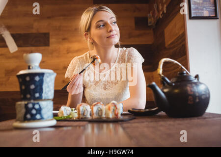 Frau Sushi-Essen im restaurant Stockfoto