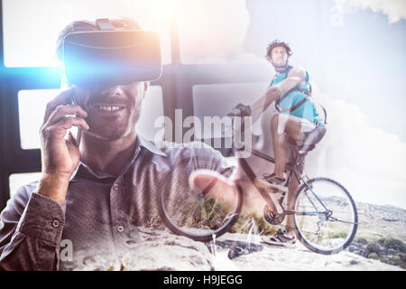 Zusammengesetztes Bild von Fit Mann Radfahren auf felsigem Gelände Stockfoto