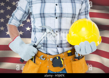 Zusammengesetztes Bild von Handyman mit Hammer und Schutzhelm Stockfoto
