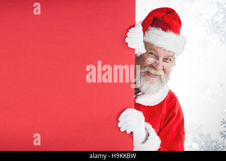 Zusammengesetztes Bild des Weihnachtsmannes spähen aus roten board Stockfoto