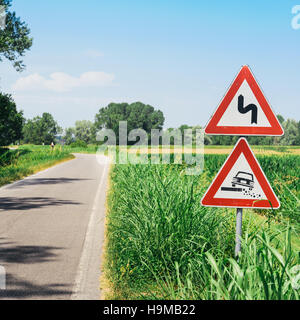 Gefährliche Schulter Ruropean Schild Kiesweg in italienischen Landschaft am Himmelshintergrund Stockfoto