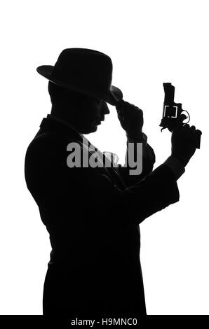 Silhouette der Privatdetektiv mit einer Pistole in der rechten Hand. Agent bleiben Seite auf Kamera und sieht aus wie Mafioso Al Capone. Kriminelle Szene. Studio gedreht Stockfoto