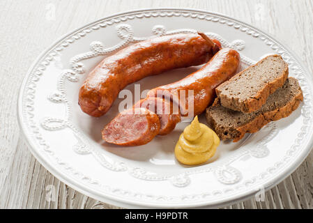 Die in Scheiben geschnittenen leckere Wurst mit Brot auf einem Teller Stockfoto