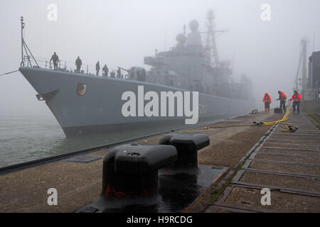 Wilhelmshaven, Deutschland. 25. November 2016. Die Fregatte "Augsburg" Mauren bei dichtem Nebel an der Pier der marine Station Wilhelmshaven, Deutschland, 25. November 2016. Das deutsche Militär Fregatte kehrte von einer drei-Monats-Mission gegen die Terrororganisation ISIL vom Mittelmeer entfernt. Foto: Ingo Wagner/Dpa/Alamy Live News Stockfoto