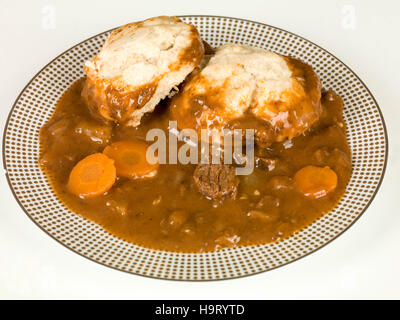 Traditionelle Rindfleisch-Eintopf und Knödel Mahlzeit vor einem weißen Hintergrund Stockfoto