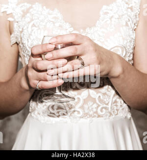 Nahaufnahme von einer Braut die Hände mit einem Glas Wein Stockfoto