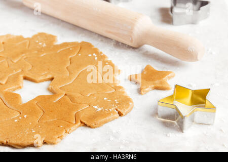 Vorbereitung Weihnachten Lebkuchen mit Cutter, Ingwer Teig - festliche hausgemachte Weihnachtsbäckerei Stockfoto