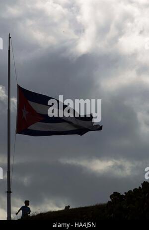 (161127)--Havanna, 27. November 2016 (Xinhua)--A Boy steht unter einer kubanischen Nationalflagge auf Halbmast zu Ehren des kubanischen Revolutionsführer Fidel Castro in Havanna, die Hauptstadt von Kuba, am 27. November 2016. Die kubanische Regierung hat neun Tage der nationalen Trauer bis zum 4. Dezember für Fidel Castro erklärt der späten Freitag im Alter von 90 Jahren verstorben. (Xinhua/David De La Paz) Stockfoto