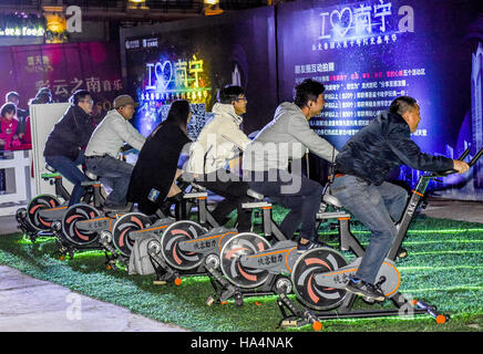 Nanning, Nanning, China. 26. November 2016. Nanning, CHINA-26. November 2016: (nur zur redaktionellen Verwendung. CHINA aus) Menschen Reiten Fahrräder, Strom für wunderbare Licht-Show in Nanning, Hauptstadt von Südwesten Chinas autonome Region Guangxi Zhuang am 26. November 2016 machen. Die Fahrräder, eingeführt aus Amerika, können Strom, wunderbare Licht-Show für Bürgerinnen und Bürger zu schaffen machen. © SIPA Asien/ZUMA Draht/Alamy Live-Nachrichten Stockfoto