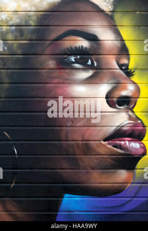 Afro-Graffiti auf Garagentor in Seitenstraße der Brick Lane Stockfoto