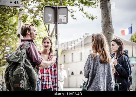 Glückliche Freunde sprechen, wobei ein Gespräch auf den Straßen von Paris Stockfoto