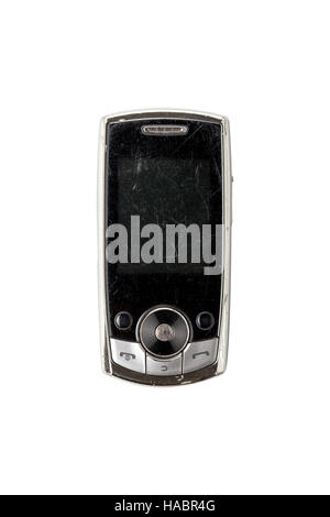 sehr alte verkratzte Handy, isoliert auf weiss Stockfoto