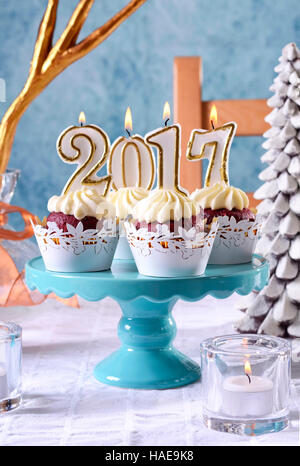 Glückliches neues Jahr 2017 Cupcakes auf einer modernen, stilvollen, festliche, blaue Gold und weiße Winter Thema Tischdekoration, Closeup vertikal. Stockfoto