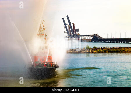 Brandbekämpfung Boot sprüht Wasser im Hafen. Stockfoto