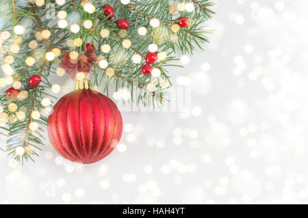 Rote Weihnachtskugel auf glänzenden silbernen Hintergrund Stockfoto