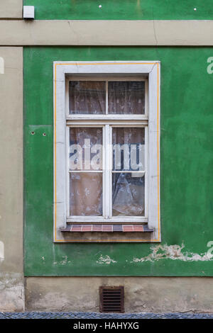 Alte Fenster in dem Wohnhaus auf einer grünen Wand. Stockfoto