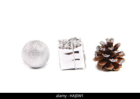 Drei dekorative Objekte für Weihnachten - Ball, Geschenk und Tannenzapfen Stockfoto