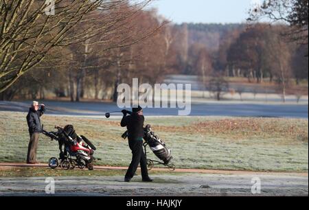 Golfer Abschlag auf dem Frost bedeckt Abschlag bei Hartley Wintney Golf Club in Hampshire, mit dem heutigen Tag markiert den offiziellen Beginn der meteorologischen Winter Temperaturen unter dem Gefrierpunkt wieder über weite Teile von England und Wales wieder gesunken. Stockfoto