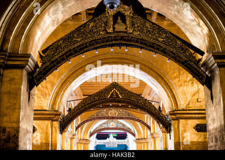 MANDALAY, Myanmar – Mahamuni Buddha Tempel (auch bekannt als Mahamuni Pagoda) ist eine hoch verehrte religiöse Stätte in Mandalay. Im Herzen steht das Mahamuni-Buddha-Bild, das als eines von nur fünf ursprünglichen Ähnlichkeiten des Buddha zu seinen Lebzeiten angesehen werden soll. Es ist mit Goldfolie bedeckt, die von Gläubigen und Pilgern als Tribut gespendet wurde. Stockfoto