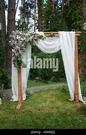 Schöne Hochzeit Bogen dekoriert mit Blumen im Park Stockfoto
