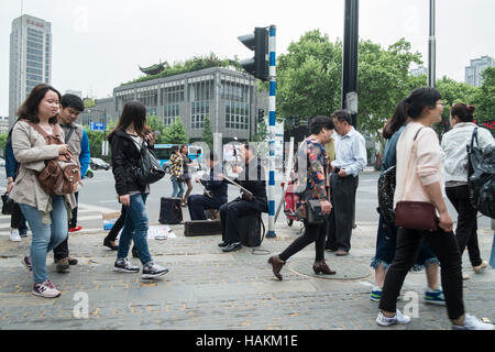 Zwei Männer auf dem Bürgersteig sitzen und spielen eines traditionellen drei saitige Version der Erhu Musical instrument Nanjing China Stockfoto