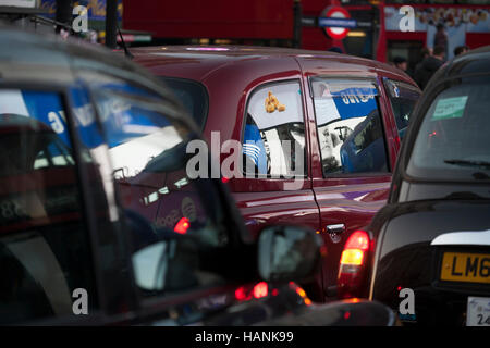 Werbung spiegelt sich in dem Taxi Windows in der Abenddämmerung am Piccadilly Circus, am 1. Dezember 2016, am Piccadilly Circus, London England. Stockfoto