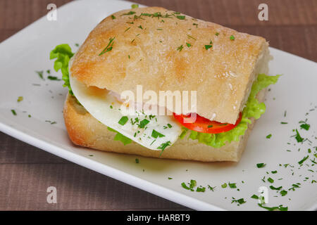 Halbe Portion Sandwich mit Schinken, Spiegelei und frischem Salat Stockfoto