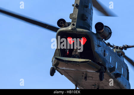 Die Ch-47 Chinook-Hubschrauber mit Crew-Mitglied an der hinteren winken mit großen roten Händen bei S Stockfoto