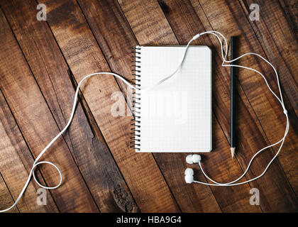 Notebook, Bleistift und Kopfhörer Stockfoto