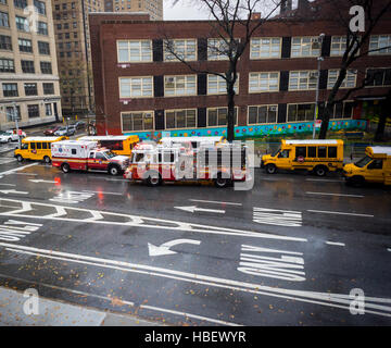 Schulbusse warten auf die Entlassung von ihren Passagieren gesellen sich Krankenwagen FDNY und Feuerwehrauto auf Dienstag, 29. November 2016.  (© Richard B. Levine) Stockfoto