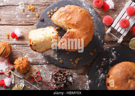 Weihnachten Panettone Brot mit Trockenfrüchten und festliche Dekoration Nahaufnahme auf dem Tisch. horizontale Ansicht von oben Stockfoto