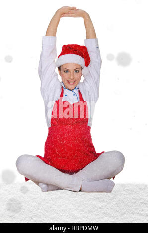 schöne Koch im Weihnachtsmann-Mütze mit Schnee Stockfoto