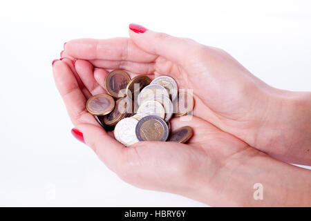 Weibliche Hand, die Euro-Münze Stockfoto