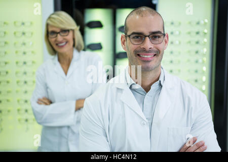 Lächelnd Optometristen stehend mit Arme gekreuzt Stockfoto