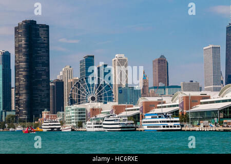 Das Navy Pier in Chicago, Illinois mit Kreuzfahrtschiffen und Ausflugsboote und Riesenrad vor der Skyline von Chicago Stockfoto