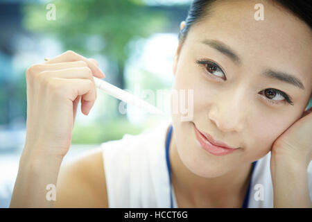 Porträt von lächelnden Geschäftsfrau mit einem Kugelschreiber Stockfoto