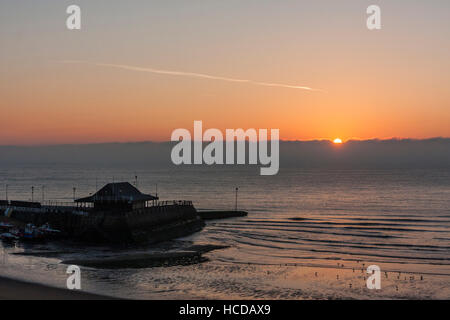 England, Broadstairs. Dämmerung, Sonnenaufgang brechen über den Ärmelkanal und den Hafen in der Silhouette. Stockfoto