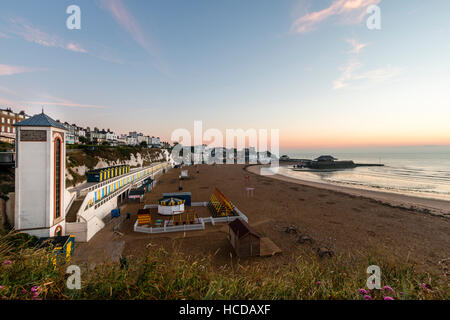 Broadstairs Meer, Lift-Welle, Klippen, Umkleidekabinen am Strand und Meer mit Strand, Meer und Hafen während der Sunrise, (unsichtbar), Licht. Stockfoto