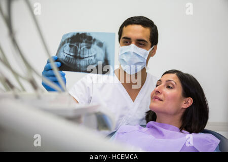 Junge männliche Zahnarzt Röntgen mit der Patientin zu prüfen Stockfoto